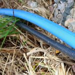 Submersible Pump Wire outdoors on rocks and grass